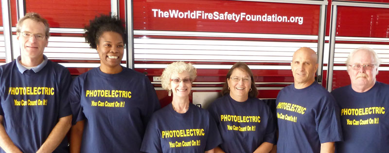 Chief Marc McGinn (2nd from right) with Albany Fire Department staff with new sign-written fire engine and T shirts